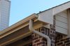 Roof gutter and downspout on a brick house under the eaves