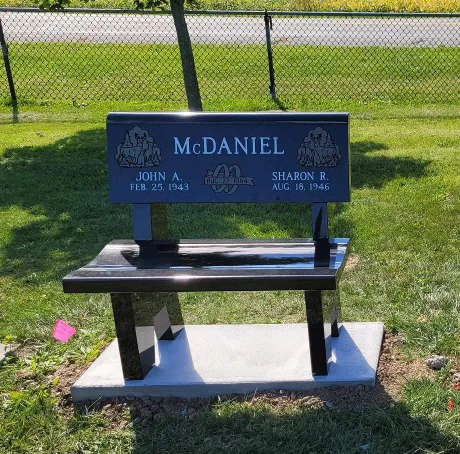 Black granite memorial bench engraved with