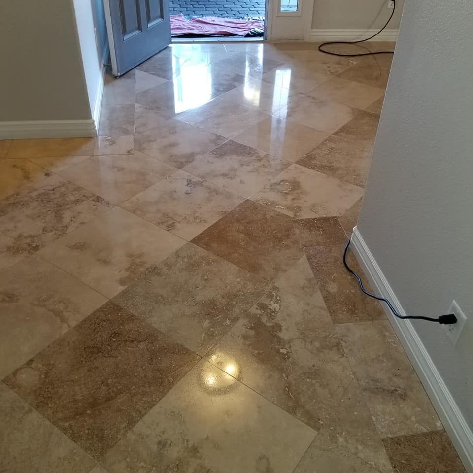 Marble-tiled hallway with an open doorway and a cord along the right wall.