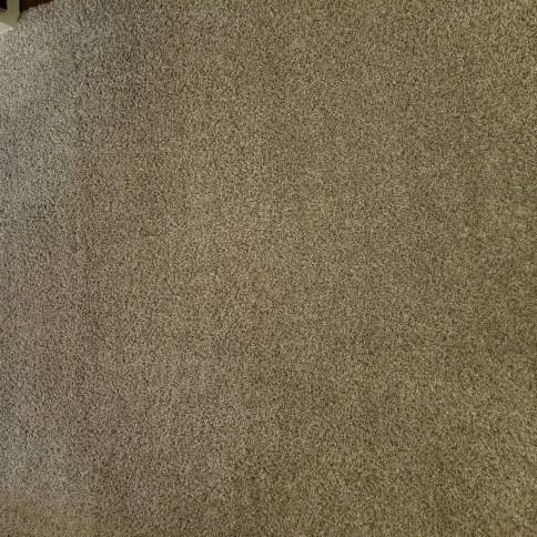 Close-up of a beige and brown textured carpet or fabric surface