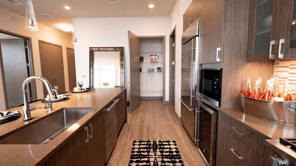 4th and Park kitchen with stainless steel appliances and wooden cabinets.
