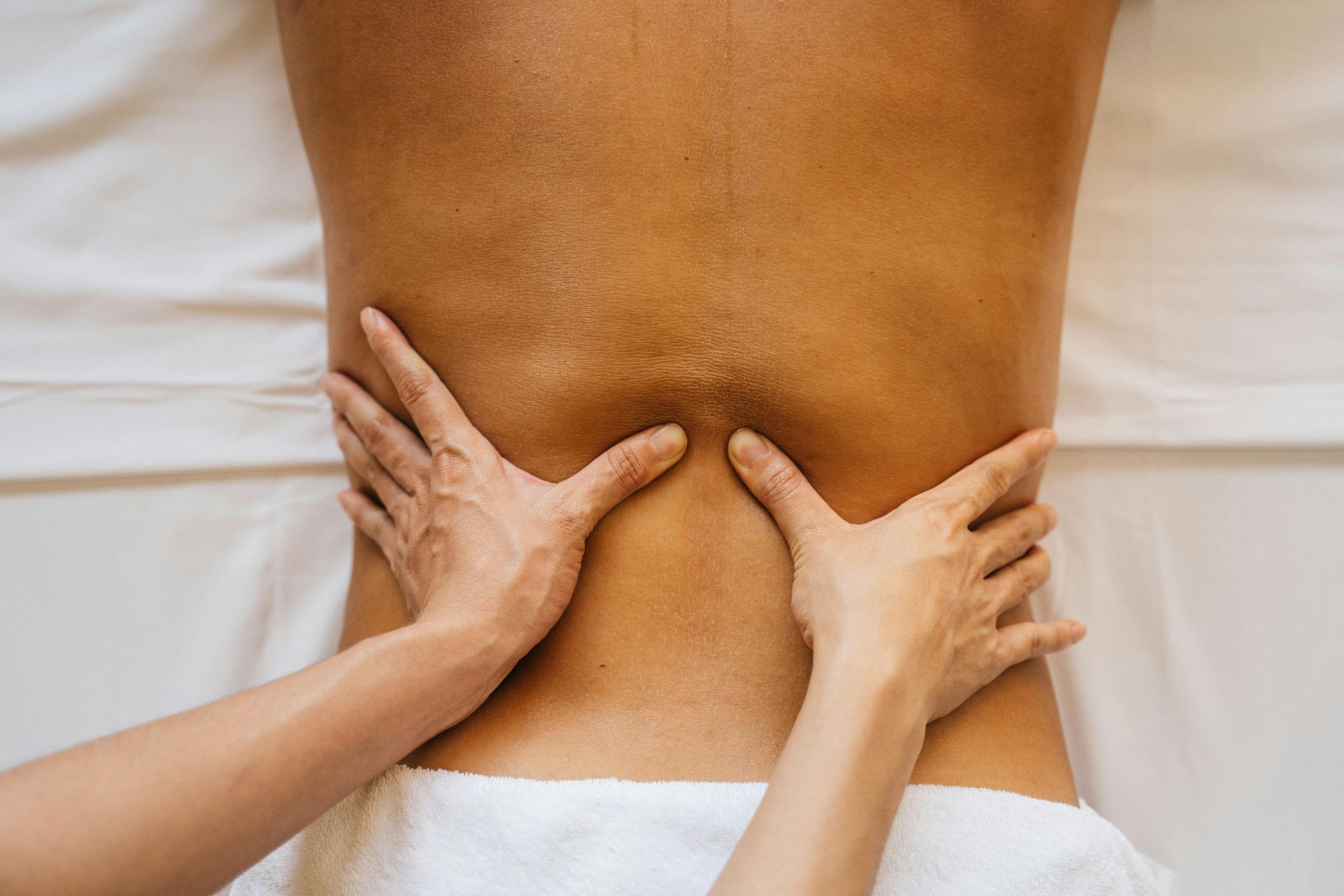A woman is giving a man a massage on his back.