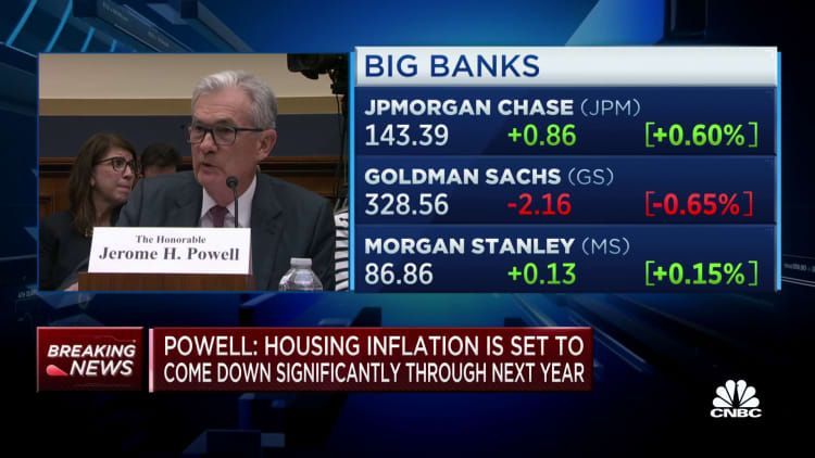 A man is giving a speech in front of a screen that says big banks