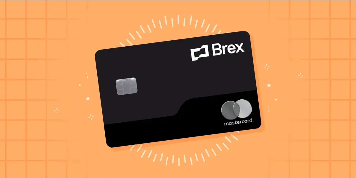 A black credit card is sitting on top of an orange surface.