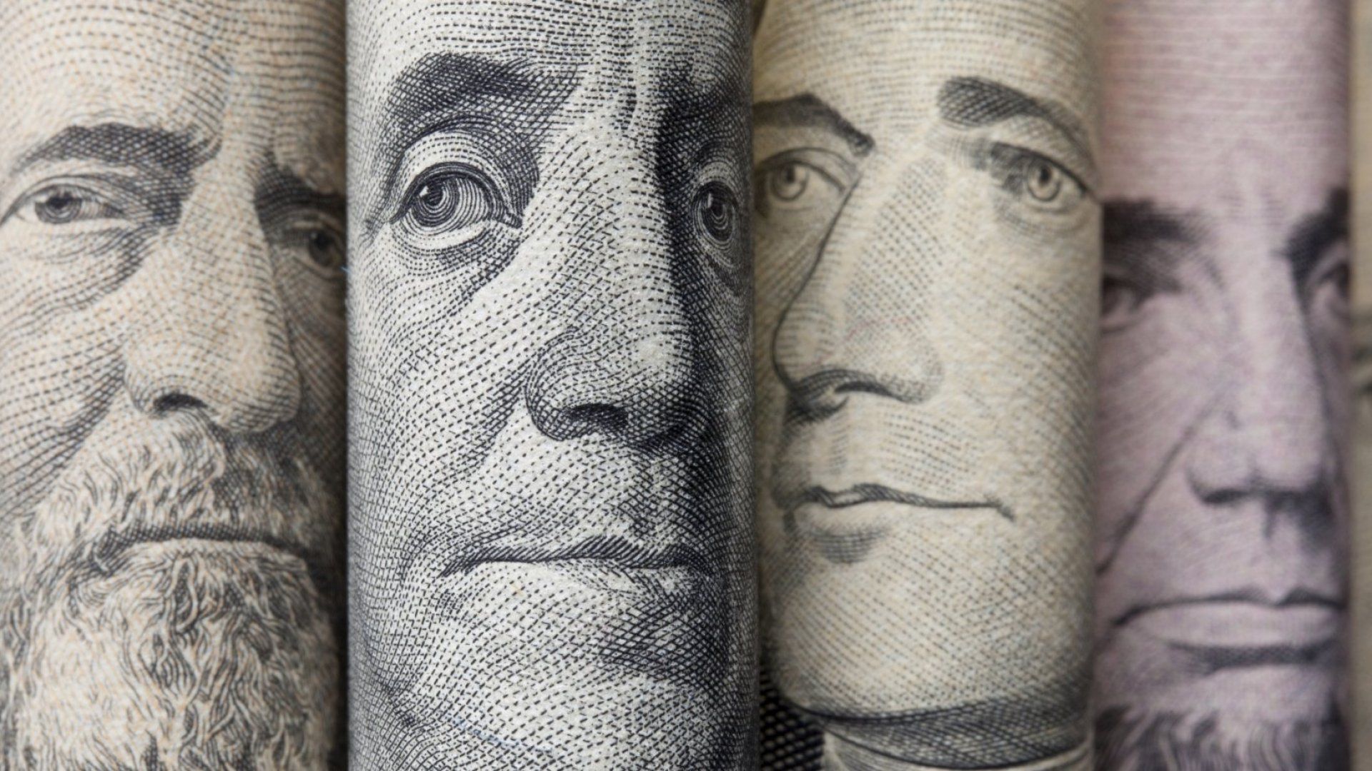 A row of dollar bills with portraits of presidents on them