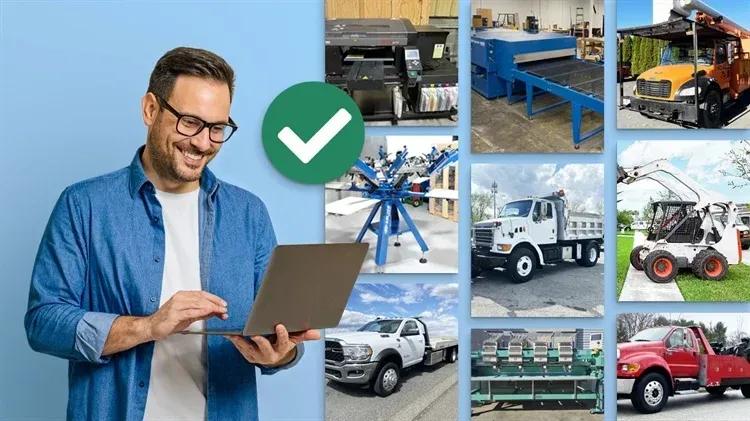 A man is holding a laptop in front of a collage of pictures of trucks.