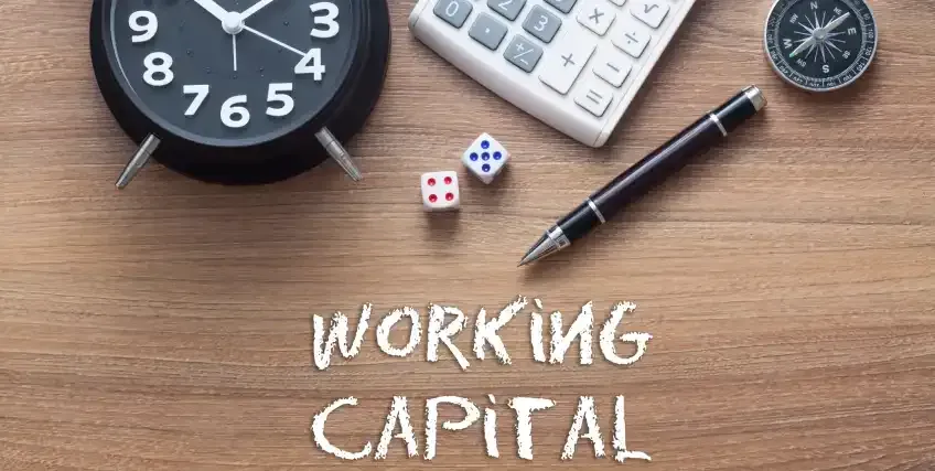 A clock , calculator , pen , dice and compass are on a wooden table.