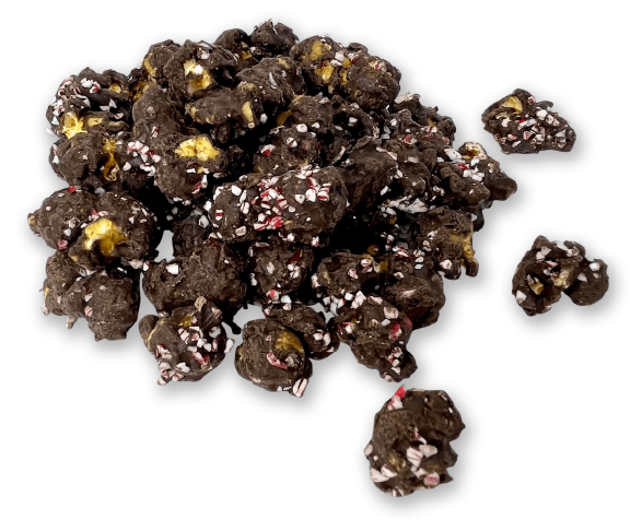 Pile of dark chocolate-covered nuts or candy clusters with colorful sprinkles on a white background