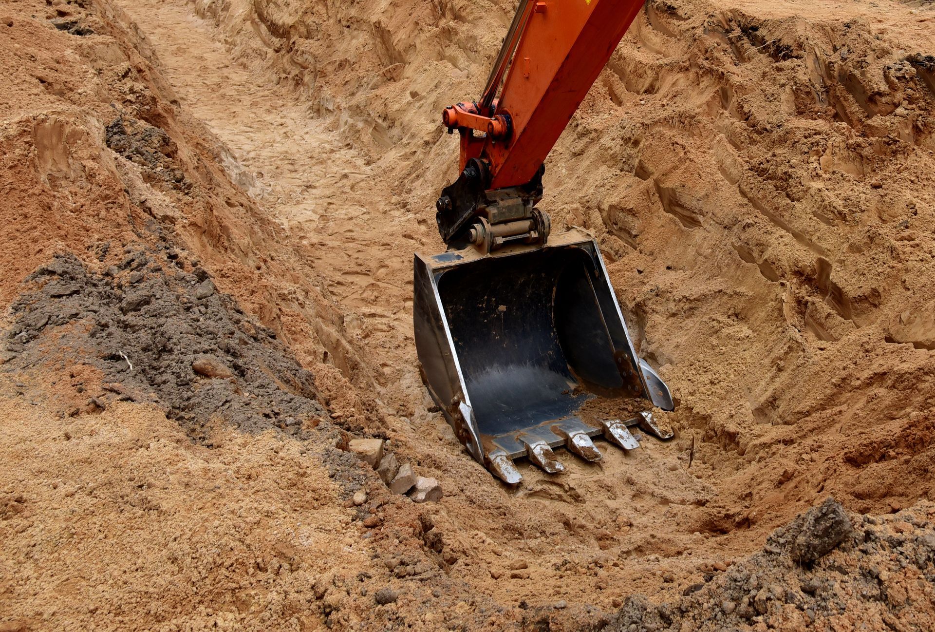 A bulldozer is digging a hole in the dirt.