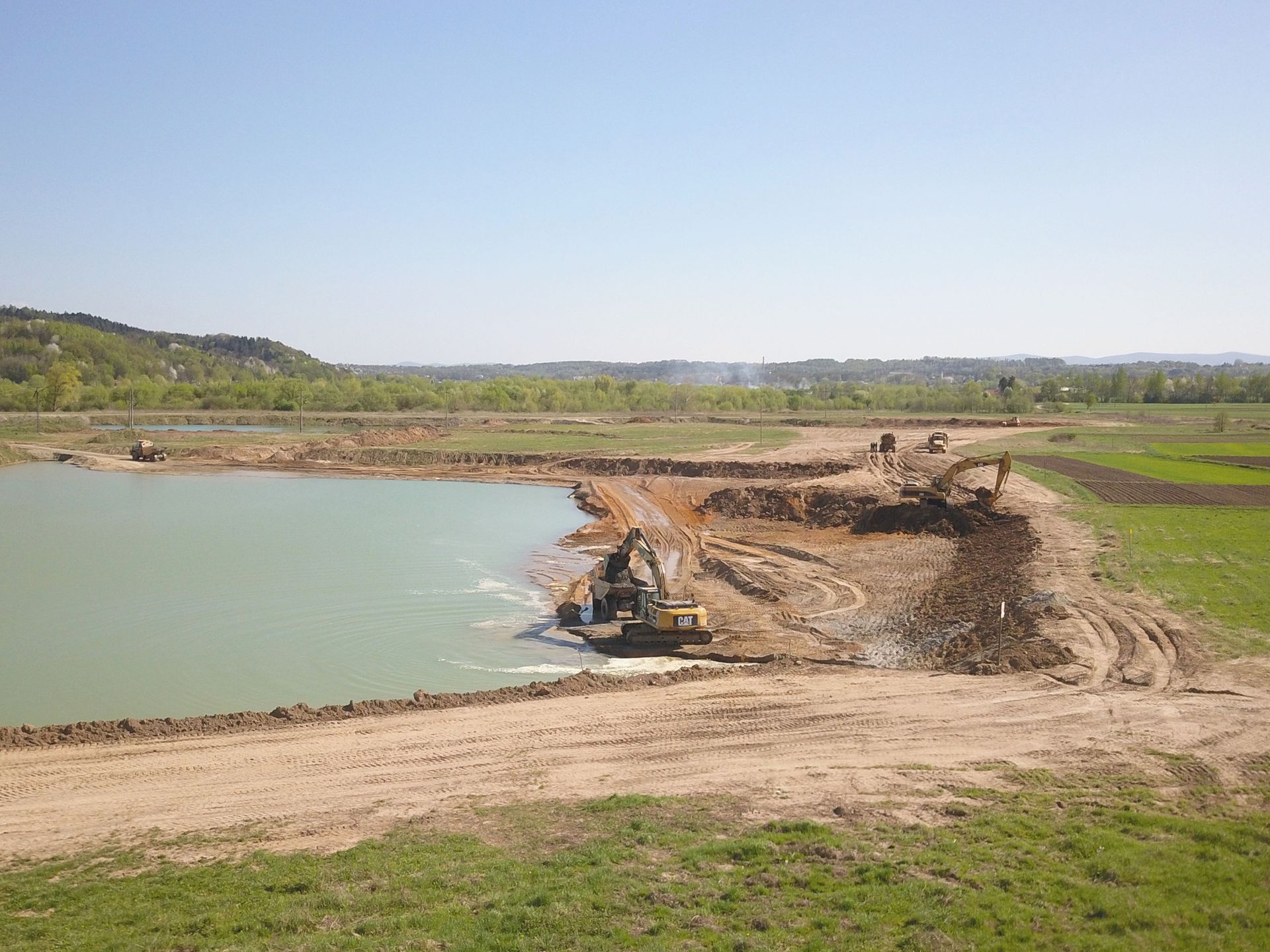 A large body of water is being filled with dirt and water.
