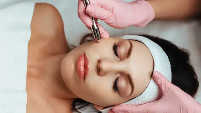 A woman is getting a facial treatment at a beauty salon.