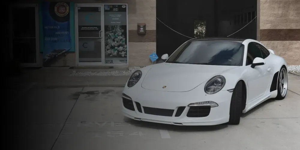 White sports car parked outside a building