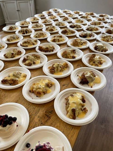 Many Plates Of Food Are Lined Up On A Wooden Table — Tru Blu Catering In Lake Cathie, NSW