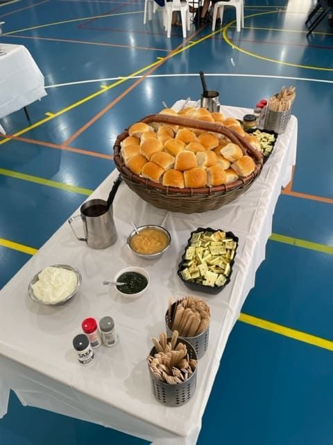 A Table With A Basket Of Bread On It — Tru Blu Catering In Woolgoolga, NSW