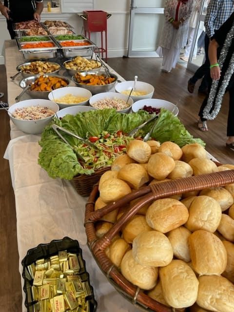A Buffet Table With A Basket Of Rolls And Bowls Of Food — Tru Blu Catering In Lake Cathie, NSW