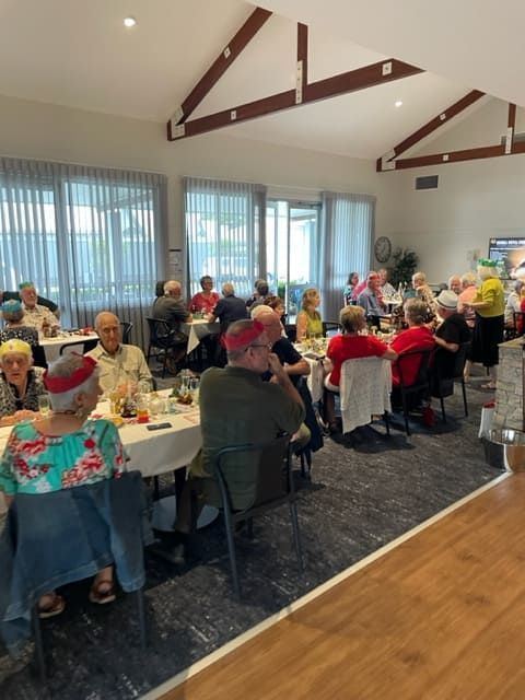 A Group Of People Are Sitting At Tables In A Restaurant — Tru Blu Catering In Lake Cathie, NSW