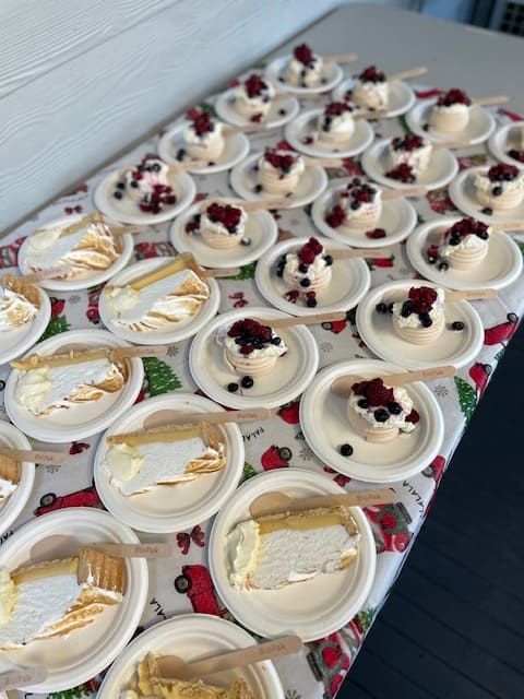 A Table Topped With Plates Of Desserts Including Lemon Meringue Pie — Tru Blu Catering In Sawtell, NSW