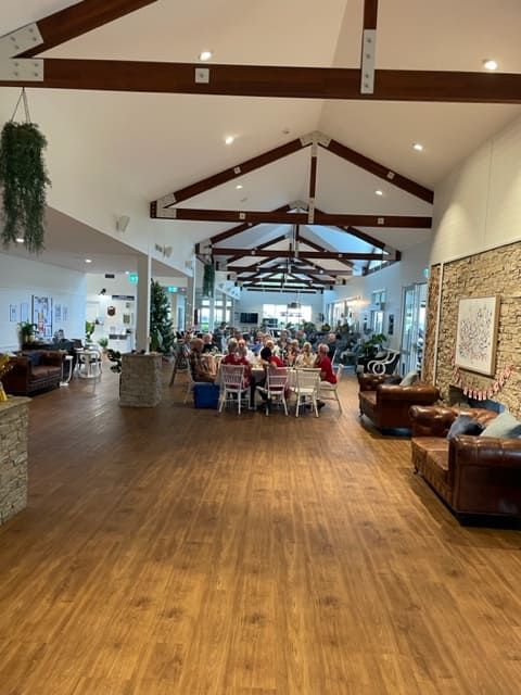 A Large Room With People Sitting At Tables And Chairs — Tru Blu Catering In Lake Cathie, NSW