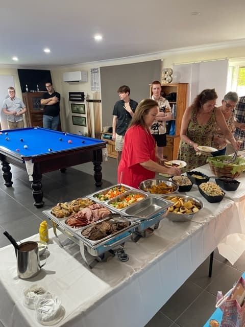 The People Are Standing Around A Buffet Table With A Pool Table In The Background — Tru Blu Catering In Coffs Harbour, NSW