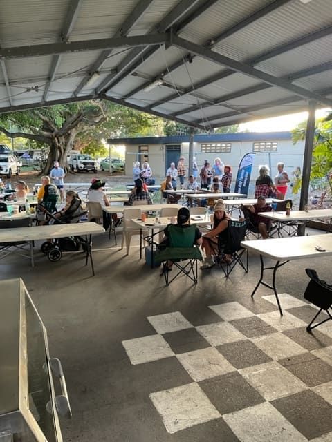 A Group Of People Are Sitting At Tables Under A Canopy — Tru Blu Catering In Taree, NSW