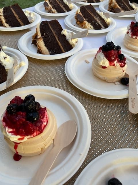 A Table Topped With Plates Of Desserts Including One With Berries On Top — Tru Blu Catering In Nambucca, NSW