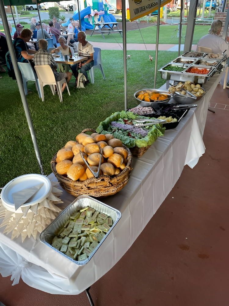 A Buffet Table With A Variety Of Food On It Under A Tent — Tru Blu Catering In Port Macquarie, NSW