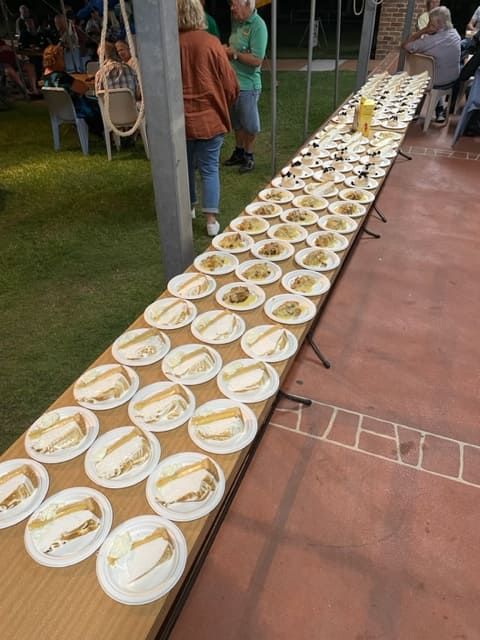 A Long Table With Many Plates Of Food On It — Tru Blu Catering In Taree, NSW