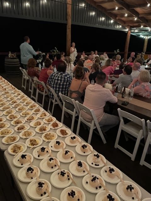 A Long Table With Many Plates Of Food On It — Tru Blu Catering In Taree, NSW