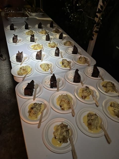 A Table Full Of Plates Of Food With Spoons And Forks — Tru Blu Catering In Port Macquarie, NSW