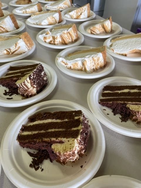 A Table Full Of Plates With Slices Of Cake On Them — Tru Blu Catering In Port Macquarie, NSW