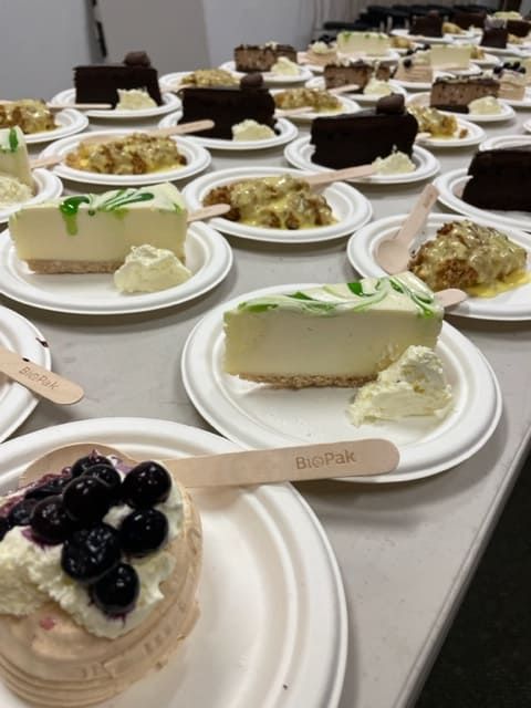 A Plates Of Desserts Including A Cheesecake With Blueberries On Top — Tru Blu Catering In Port Macquarie, NSW