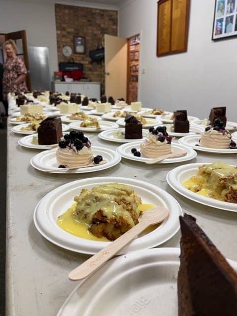 A Table Full Of Plates Of Desserts With A Wooden Spoon — Tru Blu Catering In Port Macquarie, NSW