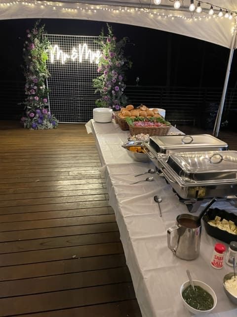 A Long Table With A Lot Of Food On It Under A Tent — Tru Blu Catering In Port Macquarie, NSW