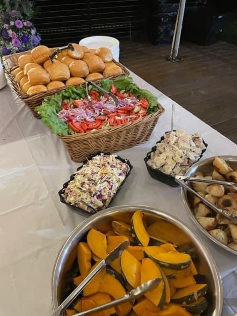 A Buffet Table With Bowls Of Food And Baskets Of Bread — Tru Blu Catering In Port Macquarie, NSW
