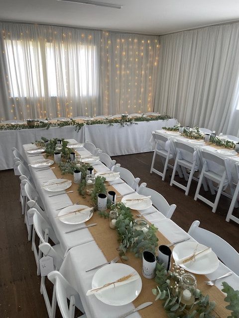 A Room Filled With Tables And Chairs Set Up For A Wedding Reception — Tru Blu Catering In Port Macquarie, NSW