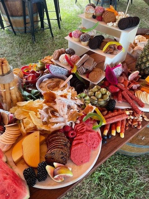 A Wooden Table Topped With Plates Of Food And Fruit — Tru Blu Catering In Kempsey, NSW