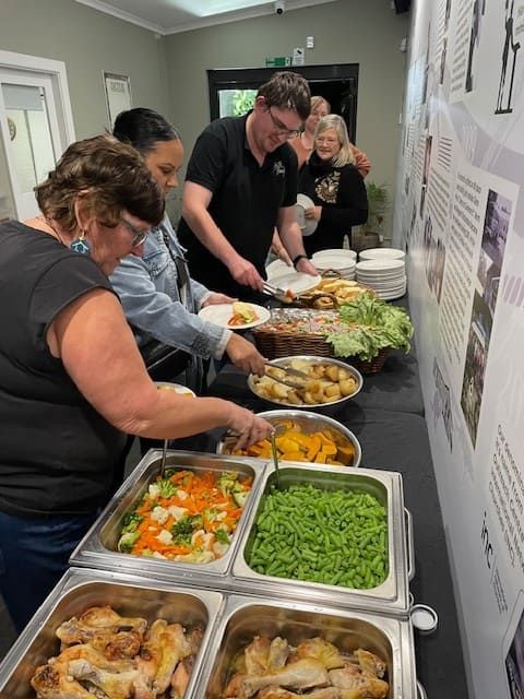 A Group Of People Are Getting Food From A Buffet Table โ Tru Blu Catering In Port Macquarie, NSW