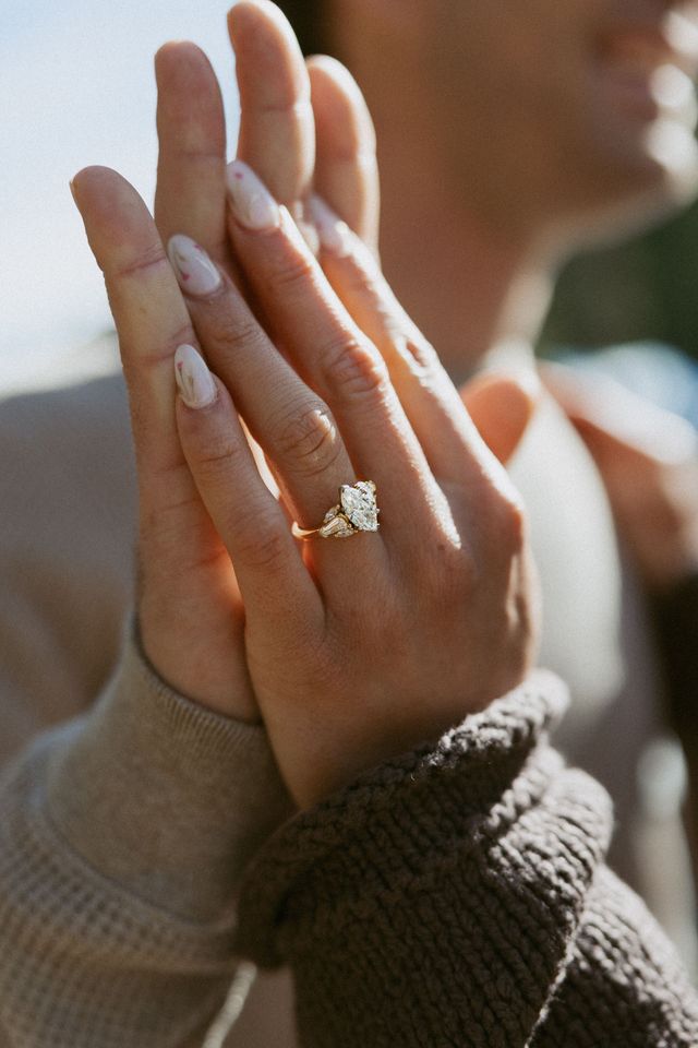 Jeweler setting a diamond into a white-gold solitaire ring