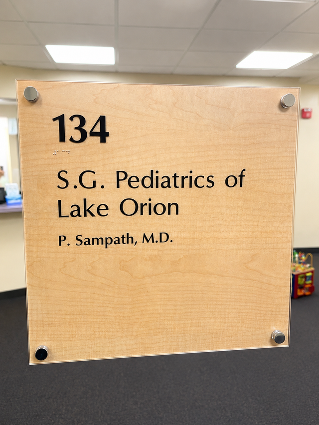 Wooden office sign for S.G. Pediatrics of Lake Orion, suite 134, with P. Sampath, M.D.