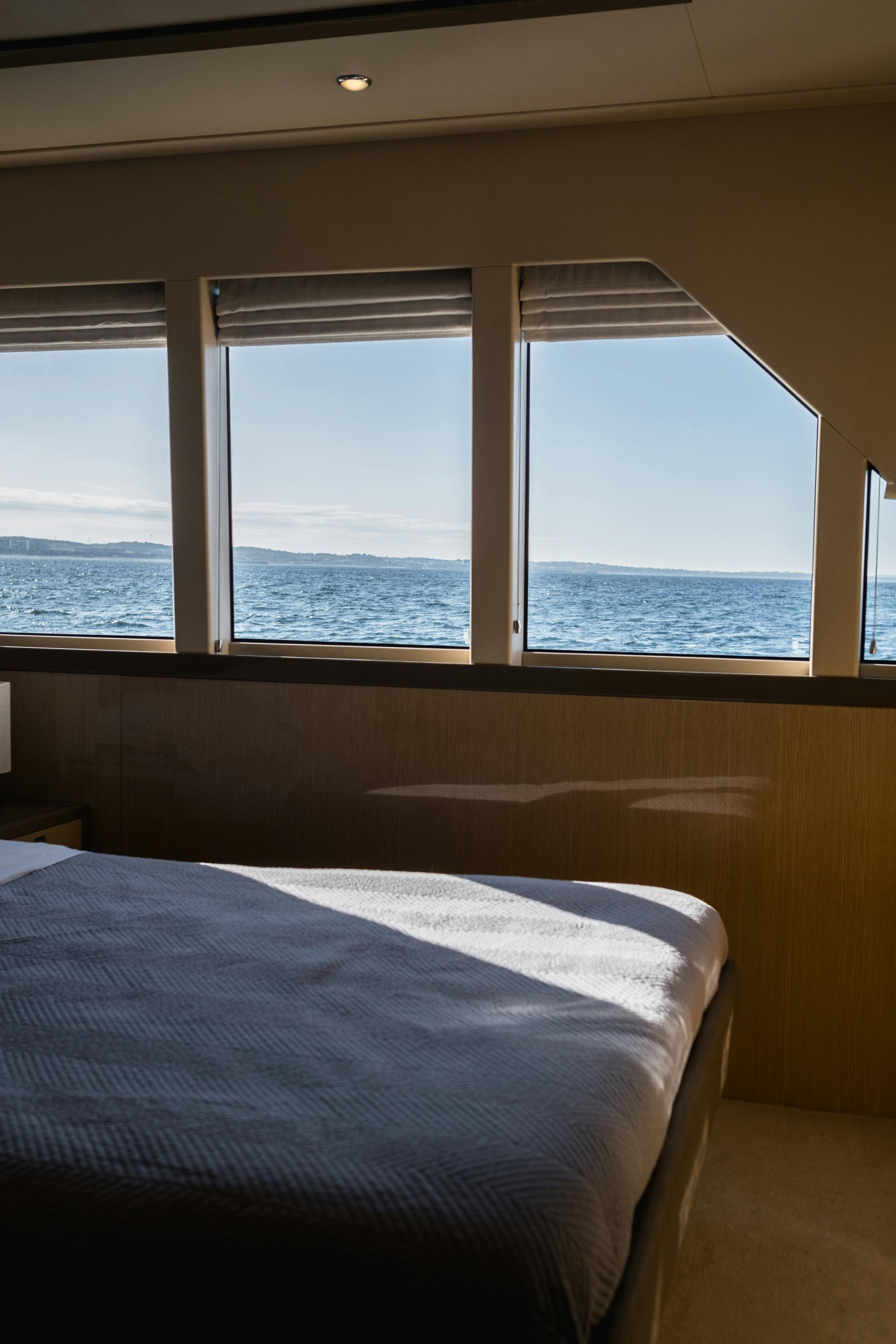 Bedroom with a bed by large windows overlooking the ocean