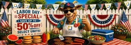 Labor Day grill sale sign with $50 off select units, burgers cooking, and a man in a hat at a barbecue display