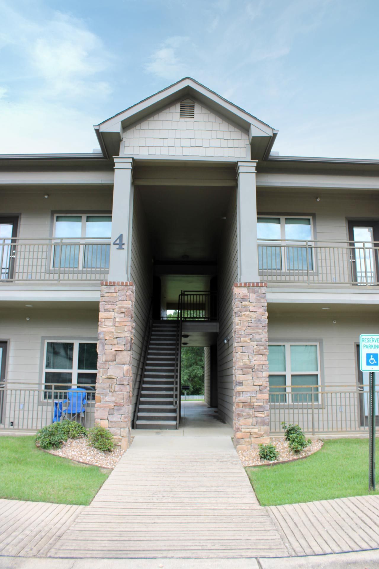 A large apartment building with stairs leading up to the second floor