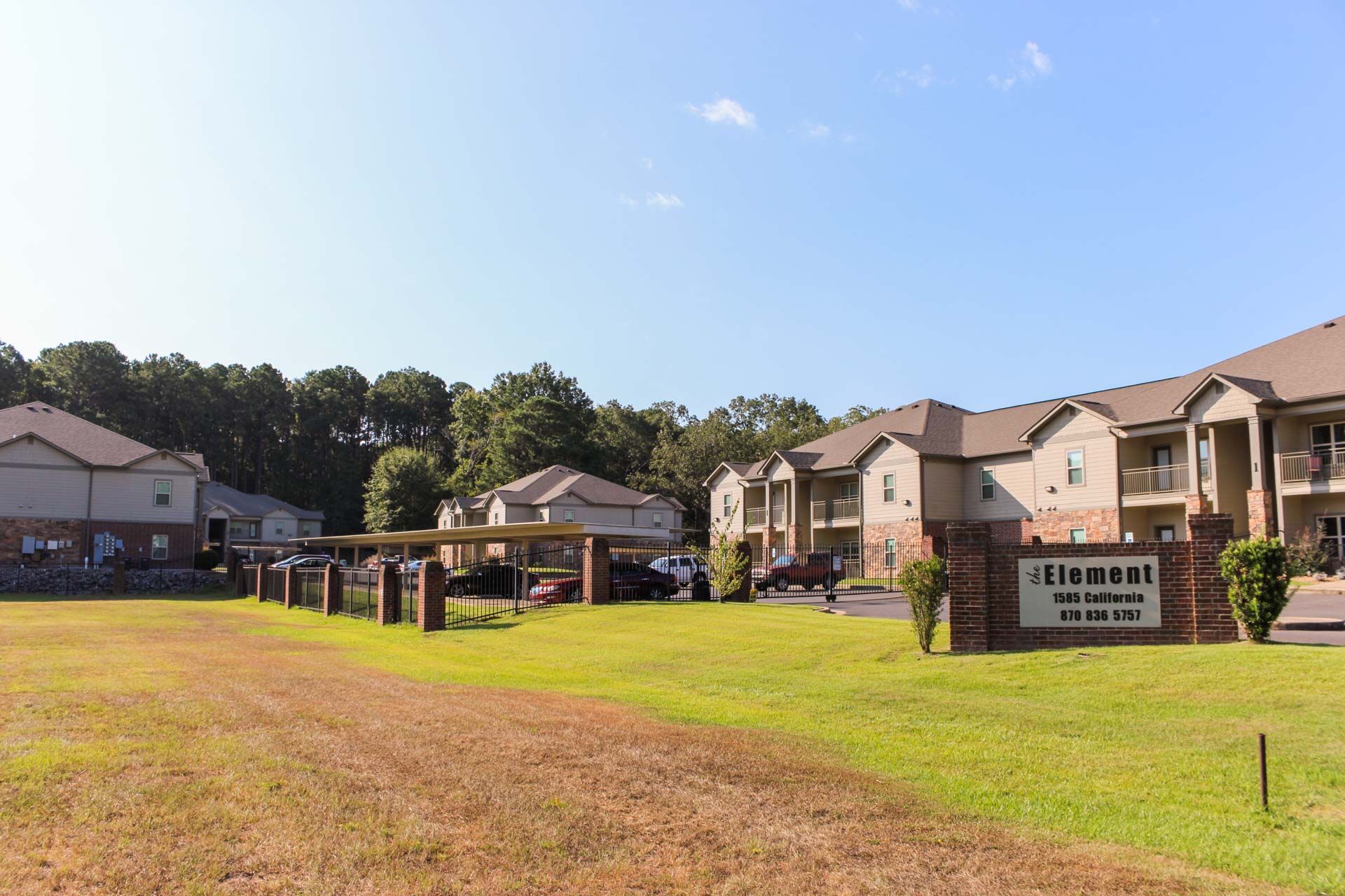 A large apartment building with a sign in front of it