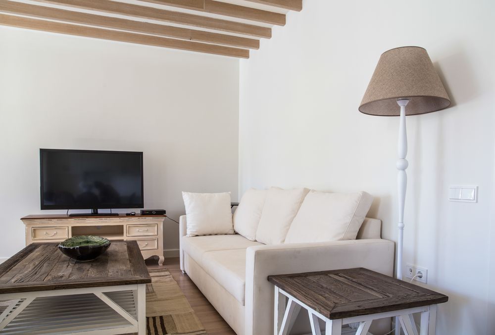 Minimal Living Room With Beige Sofa, and TV on Rustic Stand — MATV Systems Australia Pty Ltd in Wickham, NSW