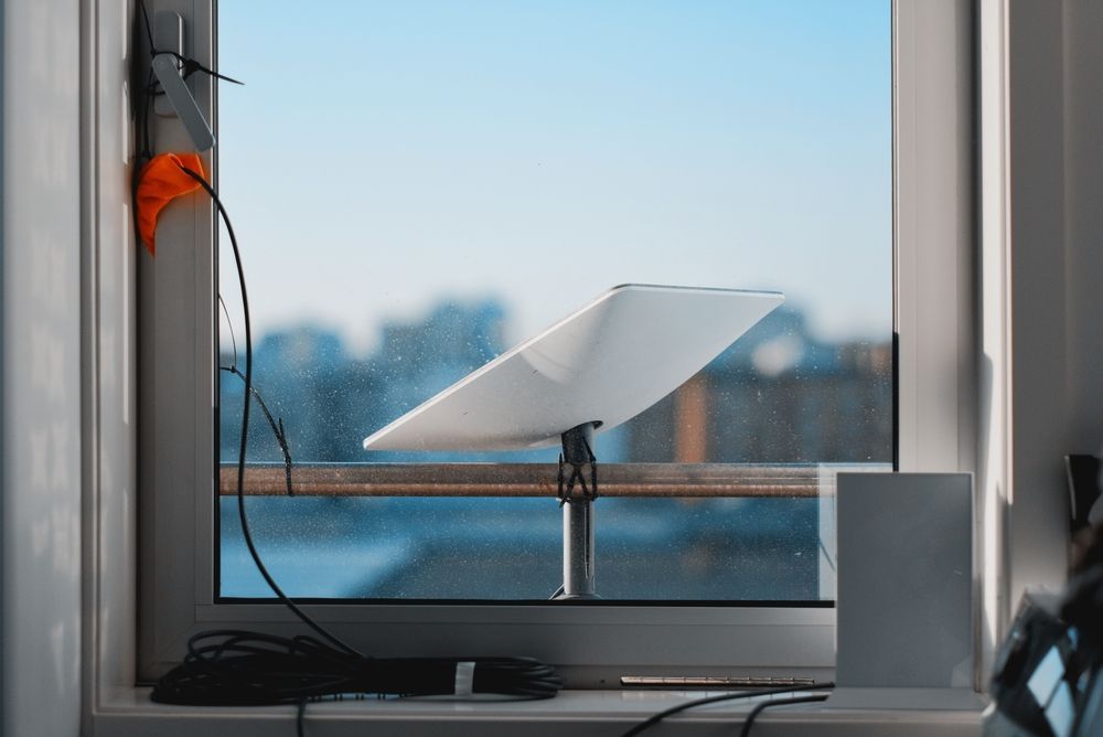 Starlink on a Windowsill Overlooking a Blurred Cityscape — MATV Systems Australia Pty Ltd in Wickham, NSW