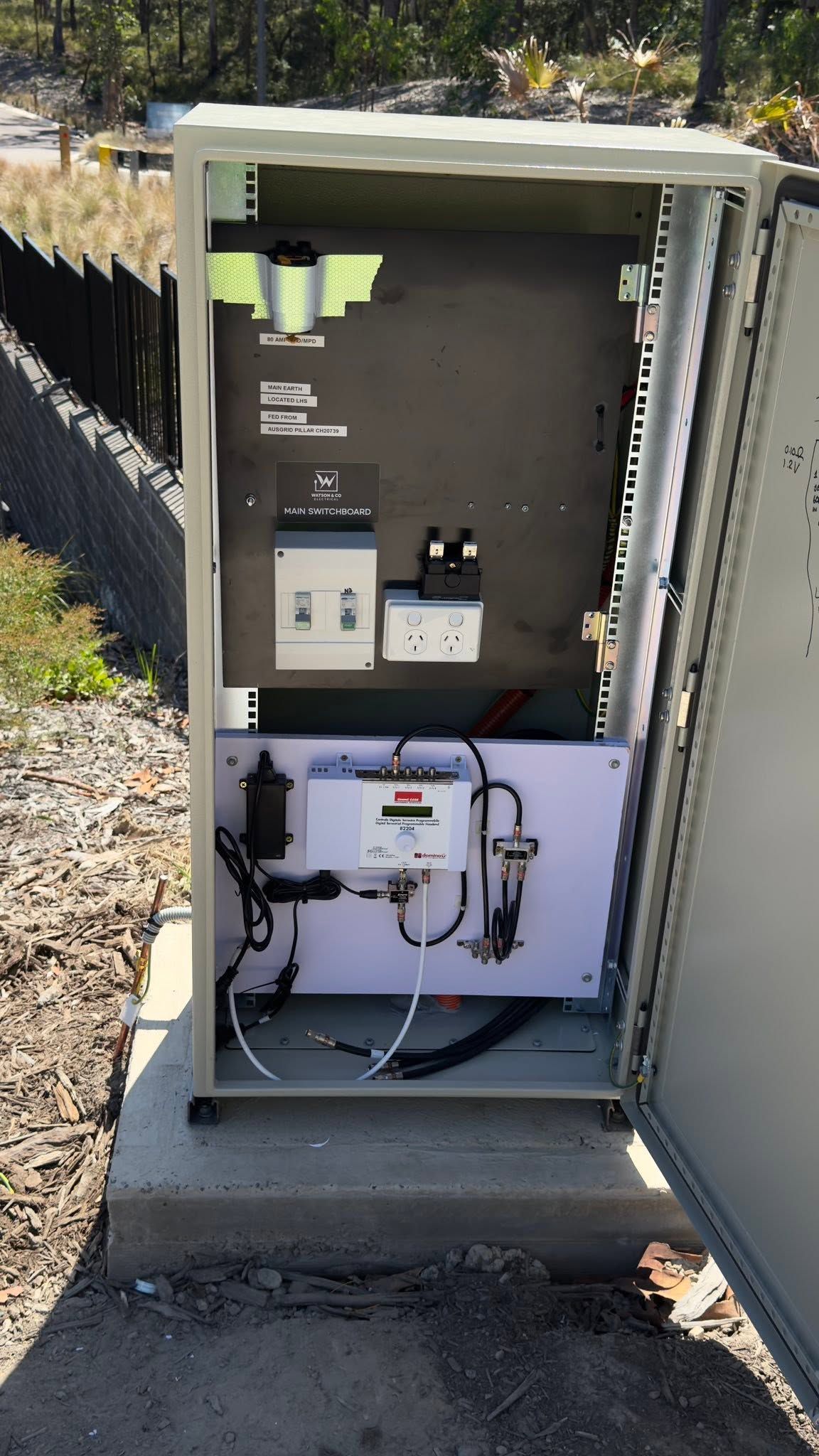 Open electrical utility cabinet with wiring, meters, and control components outdoors. — MATV Systems Australia Pty Ltd in Wickham, NSW