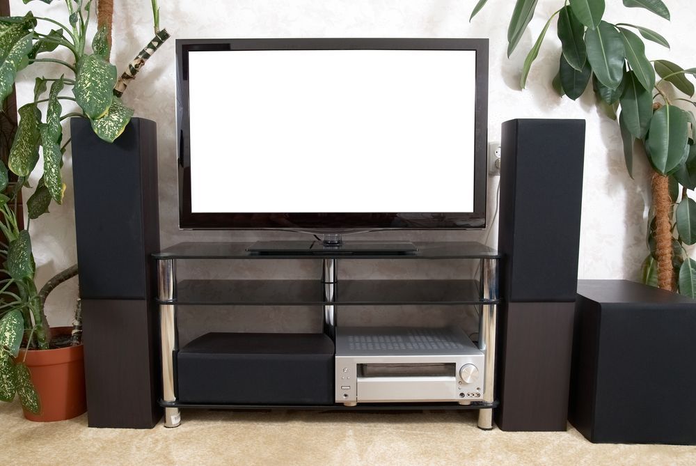 Flat-screen TV on a Glass Stand With Speakers — MATV Systems Australia Pty Ltd in Wickham, NSW