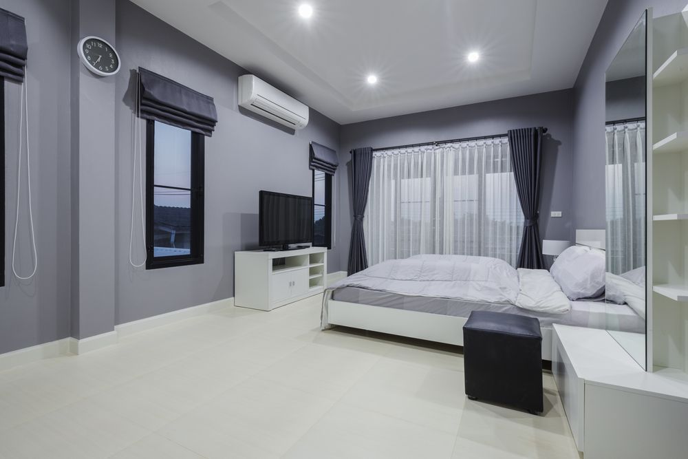 Modern Grey Bedroom With a Bed and TV — MATV Systems Australia Pty Ltd in Wickham, NSW