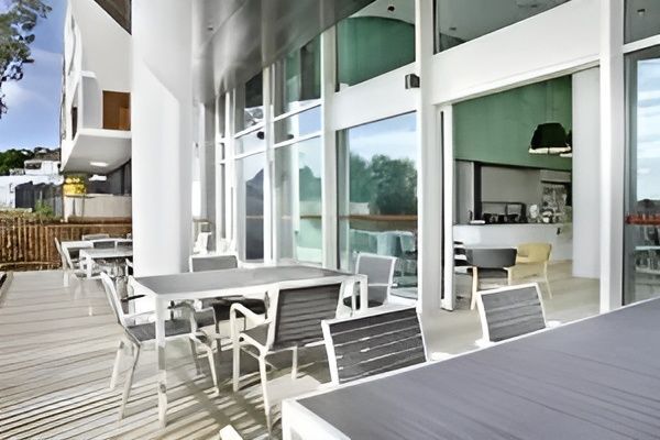 A Patio with Tables and Chairs in Front of A Building — MATV Systems Australia Pty Ltd in Wickham, NSW