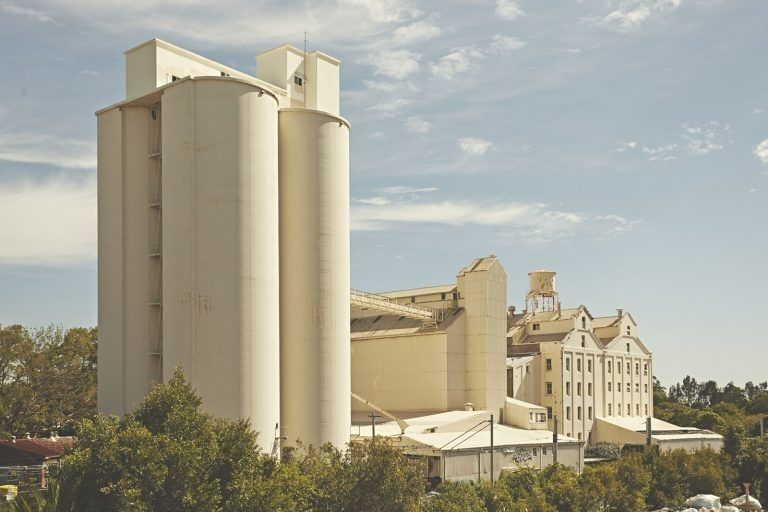 A Large White Building with A Water Tower on Top of It — MATV Systems Australia Pty Ltd in Wickham, NSW
